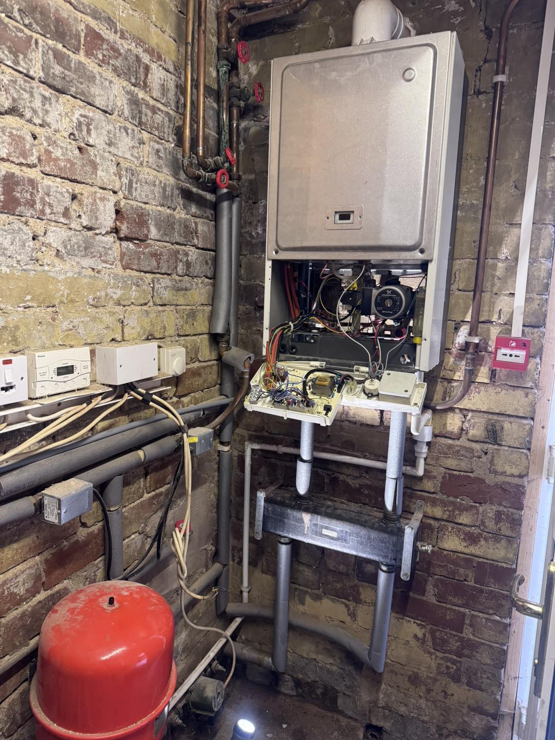 Wall mounted boiler installation with exposed pipework